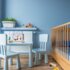 Blue baby room with floor panels, cot and small blue table and chairs | © .